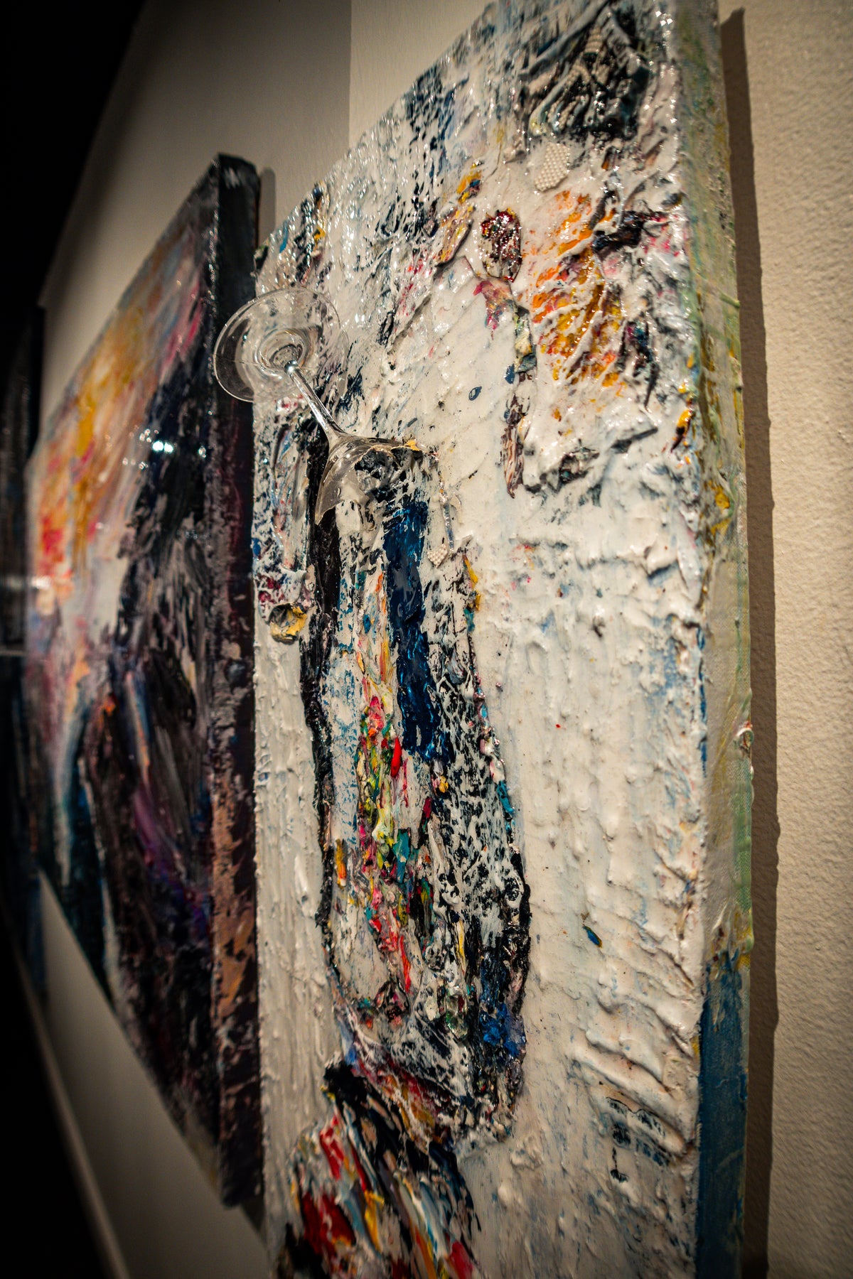 Angled image of paintings on wall at artHouse LTA